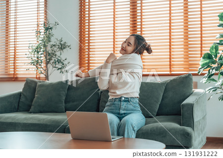 oung asian woman feeling pain in neck and shoulder after working on computer 131931222