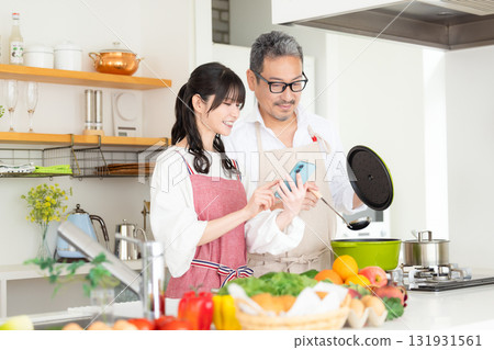 Kitchen: Middle-aged couple cooking Kitchen: Middle-aged couple cooking 131931561