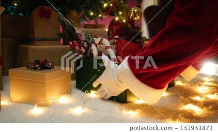 Santa Claus places basket full of gifts Santa Claus places basket full of gifts 131931871