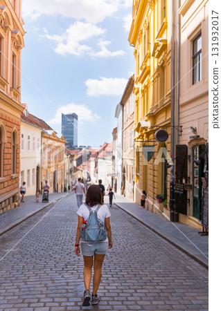Woman walking on historic cobblestone street in Zagreb, Croatia 131932017
