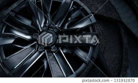 Modern black alloy wheel design with textured background for automotive enthusiasts and manufacturers 131932870