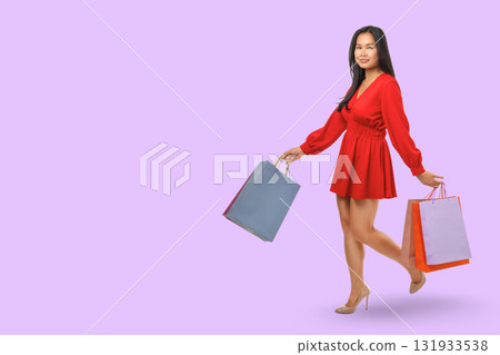 Woman in stylish outfit enjoys shopping with colorful bags Woman in stylish outfit enjoys shopping with colorful bags 131933538