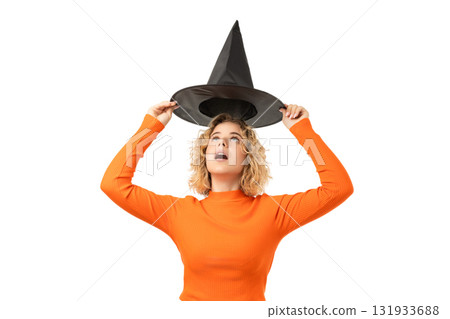 Woman shows excitement while holding a witch hat, isolated, PNG 131933688