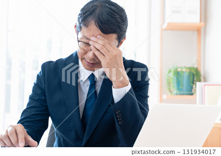 Worried middle-aged businessman Worried middle-aged businessman 131934017