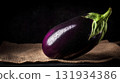 Fresh eggplants with water drops on burlap, dark photo of organic vegetables 131934386