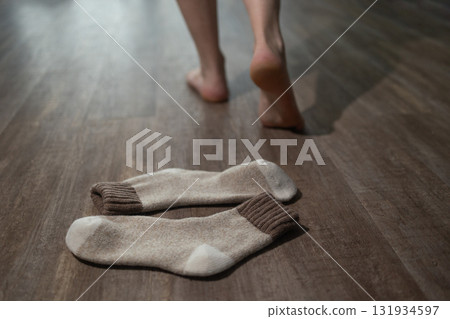 Enjoying Warmth of Underfloor Heating With Barefoot on the Wood Floor Enjoying Warmth of Underfloor Heating With Barefoot on the Wood Floor 131934597