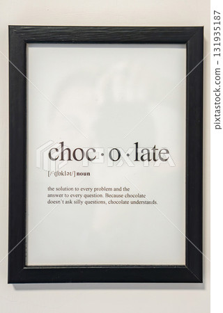 A black framed print featuring a humorous dictionary style definition of chocolate. The text is displayed on a plain white background for emphasis. A black framed print featuring a humorous dictionary style definition of chocolate. The text is displayed on a plain white background for emphasis. 131935187