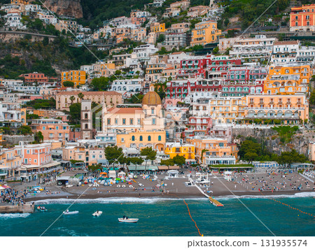 Positano on Italy's Amalfi Coast features vibrant buildings, the Church of Santa Maria Assunta, a lively beach, and turquoise Mediterranean waters. Positano on Italy's Amalfi Coast features vibrant buildings, the Church of Santa Maria Assunta, a lively beach, and turquoise Mediterranean waters. 131935574