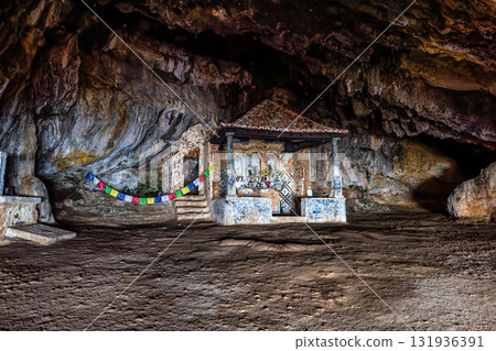 Dark interior of Lapa de Santa Margarida in Arrabida, Setubal, Portugal. Cave with small chapel of spontaneous worship 131936391