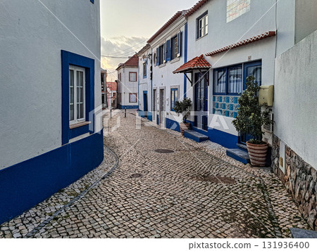 Traditional white houses with blue stripes in the streets of Ericeira in Portugal Traditional white houses with blue stripes in the streets of Ericeira in Portugal 131936400