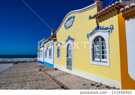 Traditional white houses with blue stripes in the streets of Ericeira in Portugal 131936402
