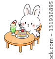 A rabbit enjoying cake and melon soda at a cafe 131936895