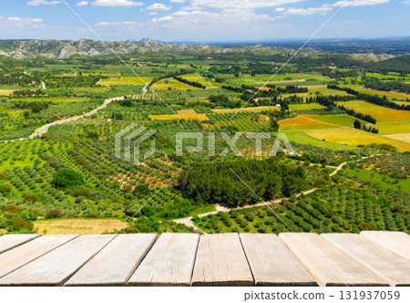 Empty wooden table and rural landscape of colorful fields, farmlands, meadows Empty wooden table and rural landscape of colorful fields, farmlands, meadows 131937059