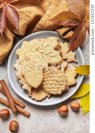Autumn cookies on plate with cinnamon and hazelnuts Autumn cookies on plate with cinnamon and hazelnuts 131937295