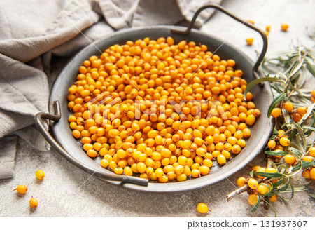 Sea buckthorn berries in bowl with branches, healthy superfood Sea buckthorn berries in bowl with branches, healthy superfood 131937307