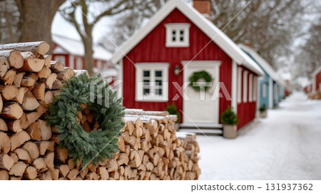 A snowy Scandinavian village with red houses and a Christmas wreath A snowy Scandinavian village with red houses and a Christmas wreath 131937362
