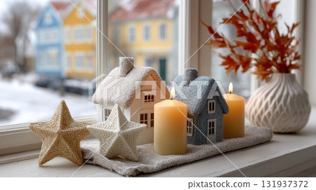 Cozy winter window sill decorated with candles miniature houses and stars 131937372