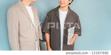 Smiling businessman with a computer (programmer, engineer, system engineer) 131937680