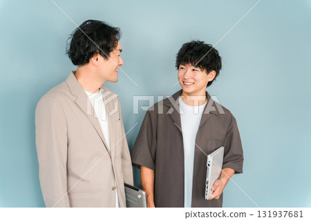 Smiling businessman with a computer (programmer, engineer, system engineer) 131937681