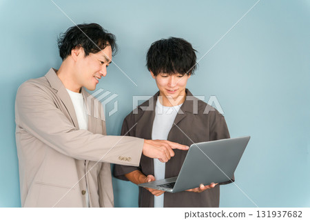 Smiling businessman with a computer (programmer, engineer, system engineer) 131937682