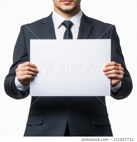 Business person in a suit holding a blank paper in a neutral setting 131937732