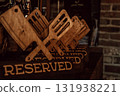 wooden reserved signs designed as cooking utensils in cozy restaurant during evening hours. closeup. 131938221