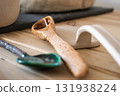 handcrafted ceramic spoon and clay tools arranged on wooden table in cozy workspace. closeup. 131938224