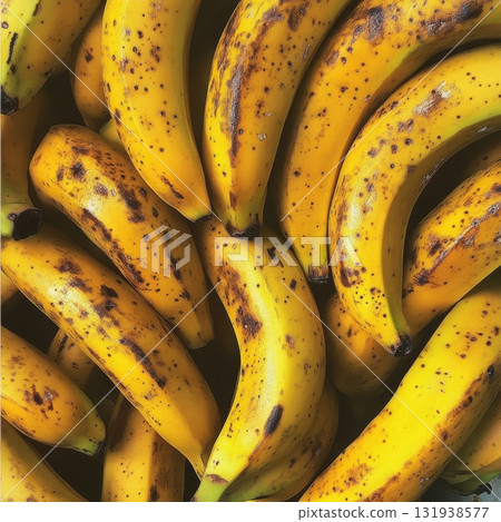 Ripe bananas displayed in a market setting, showcasing their vibrant yellow color and speckled texture Ripe bananas displayed in a market setting, showcasing their vibrant yellow color and speckled texture 131938577