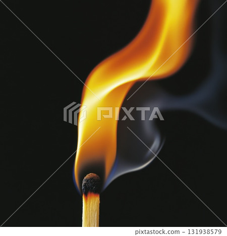 Dynamic flame rising from a lit match showcasing the beauty of fire and smoke in dark surroundings Dynamic flame rising from a lit match showcasing the beauty of fire and smoke in dark surroundings 131938579
