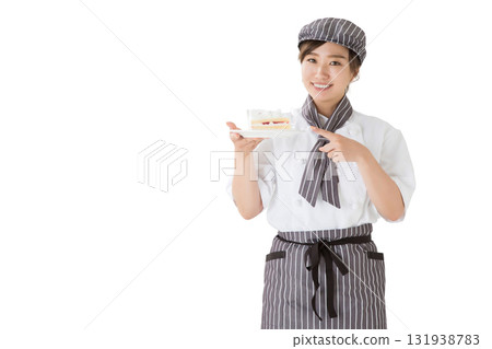 一位身穿廚師服的女士手裡拿著一塊脆餅 一位身穿廚師服的女士手裡拿著一塊脆餅 131938783