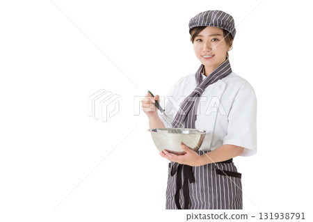 A woman wearing a chef's coat mixing whipped cream in a bowl A woman wearing a chef's coat mixing whipped cream in a bowl 131938791