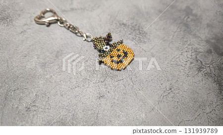 Handcrafted pumpkin-shaped keychain made of orange seed beads and glass beads Handcrafted pumpkin-shaped keychain made of orange seed beads and glass beads 131939789