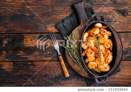 Deliciously seasoned grilled shrimp prawns with vibrant colors, a must-have for seafood lovers and culinary enthusiasts. wooden background. top view 131939945