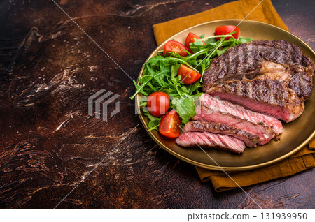 Dinner with Grilled Rib eye steak, fried dry aged beef meat. brown background. top view Dinner with Grilled Rib eye steak, fried dry aged beef meat. brown background. top view 131939950