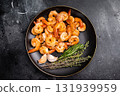Appetizing grilled shrimp prawns served on a platter, perfect for elegant dinners or casual gatherings with friends. black background. top view 131939959