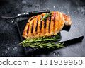 Grilled chicken breasts steaks with rosemary, farm poultry meat, top view, black background. 131939960