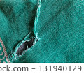 Torn fabric. Frayed cloth background for sample, presentation, safety issue, excessive acid wash warning etc 131940129