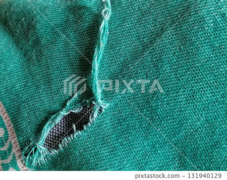 Torn fabric. Frayed cloth background for sample, presentation, safety issue, excessive acid wash warning etc Torn fabric. Frayed cloth background for sample, presentation, safety issue, excessive acid wash warning etc 131940129