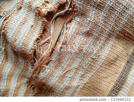 Torn fabric. Frayed cloth background for sample, presentation, safety issue, excessive acid wash warning etc Torn fabric. Frayed cloth background for sample, presentation, safety issue, excessive acid wash warning etc 131940131