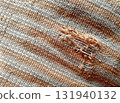 Torn fabric. Frayed cloth background for sample, presentation, safety issue, excessive acid wash warning etc 131940132