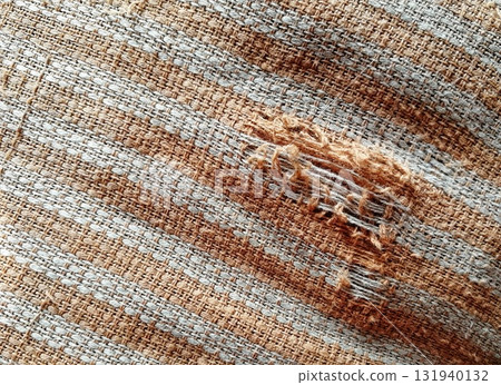 Torn fabric. Frayed cloth background for sample, presentation, safety issue, excessive acid wash warning etc Torn fabric. Frayed cloth background for sample, presentation, safety issue, excessive acid wash warning etc 131940132