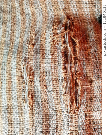 Torn fabric. Frayed cloth background for sample, presentation, safety issue, excessive acid wash warning etc Torn fabric. Frayed cloth background for sample, presentation, safety issue, excessive acid wash warning etc 131940133