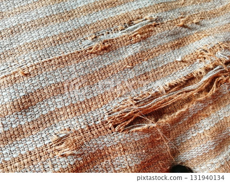 Torn fabric. Frayed cloth background for sample, presentation, safety issue, excessive acid wash warning etc Torn fabric. Frayed cloth background for sample, presentation, safety issue, excessive acid wash warning etc 131940134