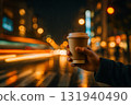 Night city and takeaway coffee in hand Night city and takeaway coffee in hand 131940490