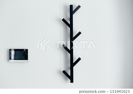 Black metal empty rack for outerwear on grey wall. Black metal empty rack for outerwear on grey wall. 131941023