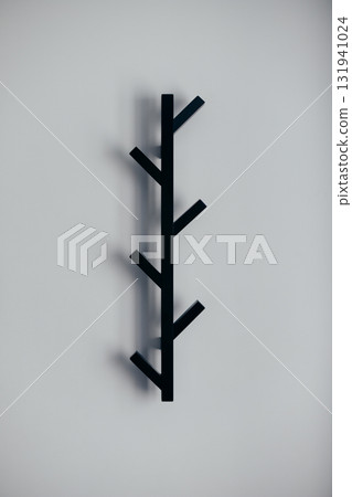 Black metal empty rack for outerwear on grey wall Black metal empty rack for outerwear on grey wall 131941024