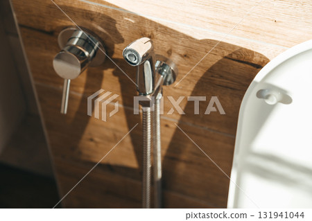 Hygiene bidet shower on wall near toilet in house Hygiene bidet shower on wall near toilet in house 131941044