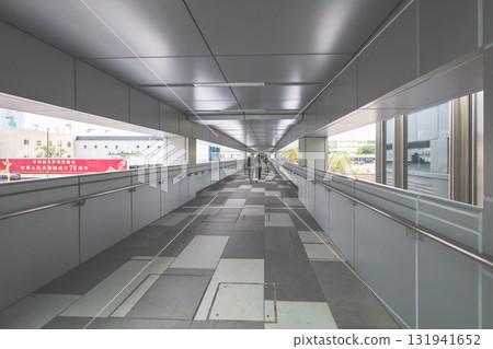 Oct 4 2025 Long Indoor Skybridge Corridor With Walking People Oct 4 2025 Long Indoor Skybridge Corridor With Walking People 131941652