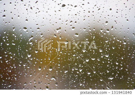 Raindrops on a window creating a beautiful, natural, and calming effect Raindrops on a window creating a beautiful, natural, and calming effect 131941840