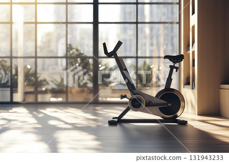 Modern exercise bike standing on a wooden floor in a sunny room with big windows overlooking a city Modern exercise bike standing on a wooden floor in a sunny room with big windows overlooking a city 131943233